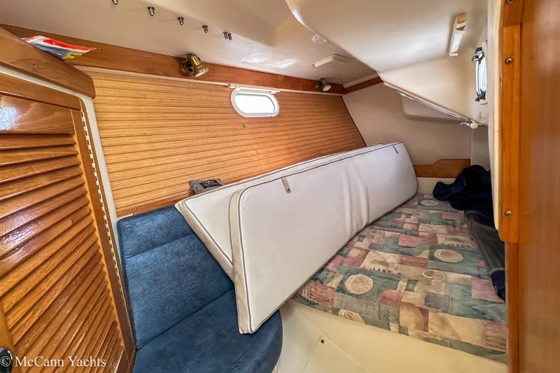 Slide: The Image of Interior cabin of 2003 Catalina 320 yacht with wooden paneling and seating. - 22