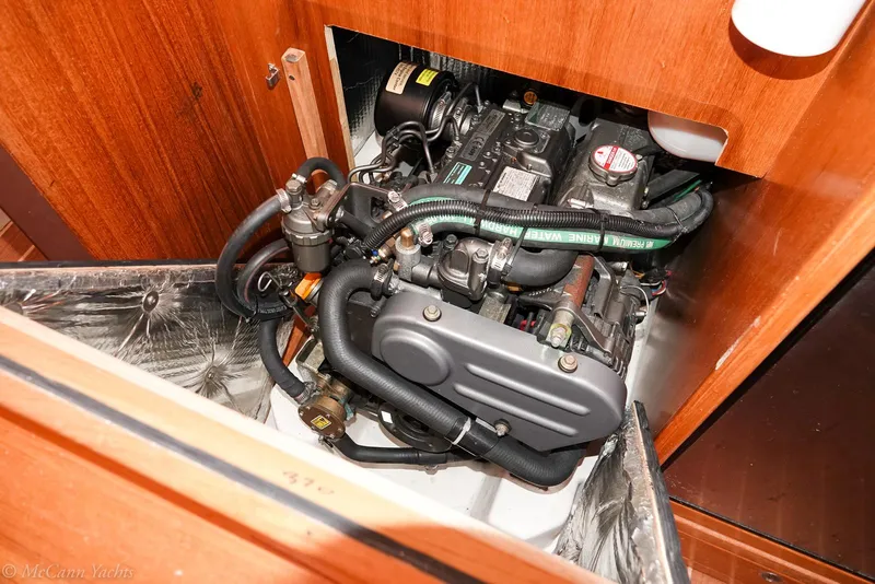 Slide: The Image of Engine compartment of a 2003 Catalina 320 sailboat, showcasing detailed mechanical components. - 29