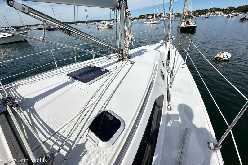 Slide: The Image of 2003 Catalina 320 sailboat deck view in a serene marina setting. - 31