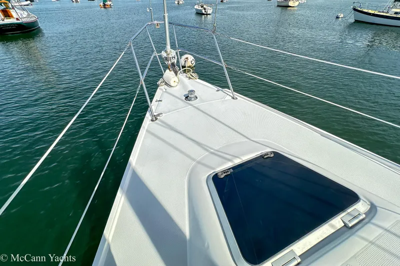Slide: The Image of Bow view of 2003 Catalina 320 sailboat on calm water with other boats nearby. - 34