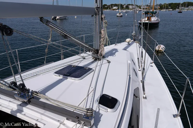 Slide: The Image of 2003 Catalina 320 sailboat deck with rigging, moored in a calm marina. - 37