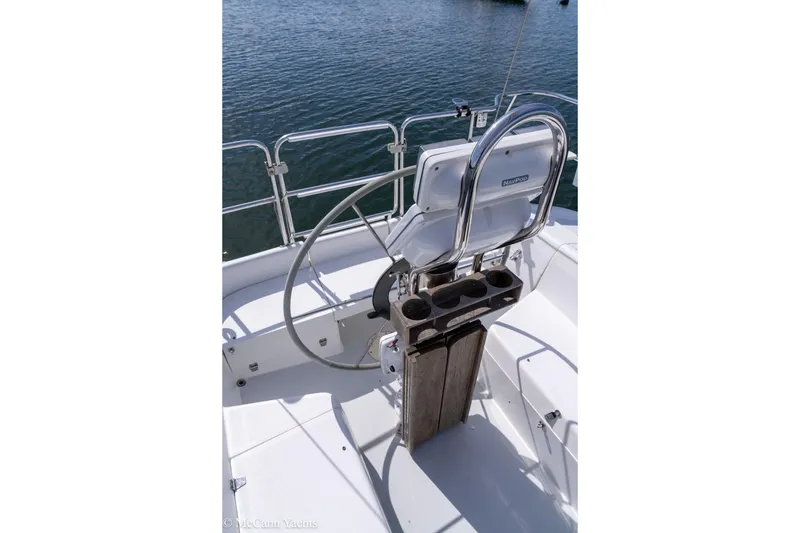 Slide: The Image of Steering wheel and cockpit of 2003 Catalina 320 sailboat on calm water. - 41