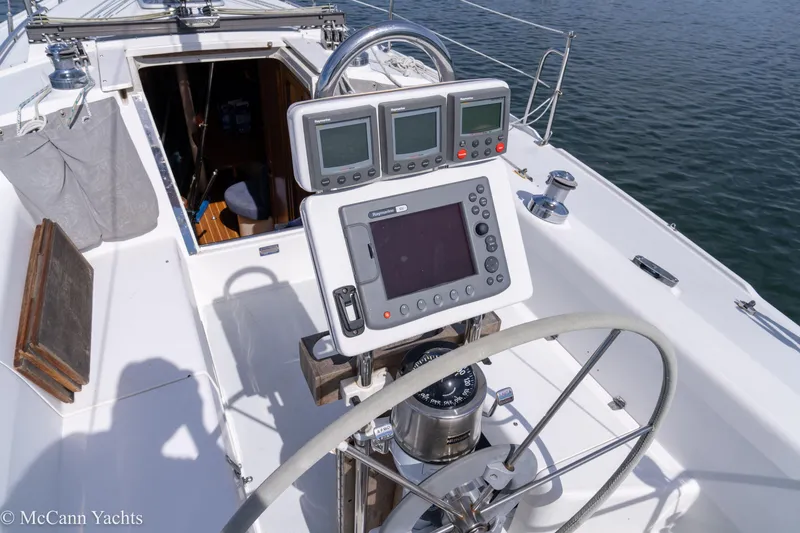 Slide: The Image of Cockpit of 2003 Catalina 320 sailboat with navigation instruments and steering wheel. - 43