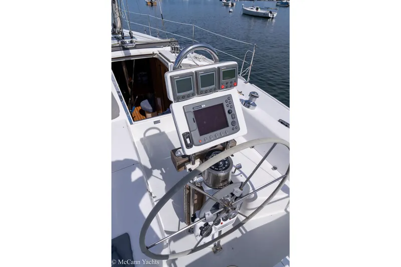 Slide: The Image of Steering wheel and navigation equipment on 2003 Catalina 320 yacht, docked in marina. - 44