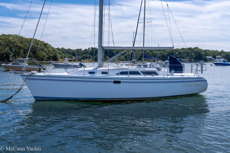 Slide: The Image of 2003 Catalina 320 sailboat anchored in a scenic harbor. - 45