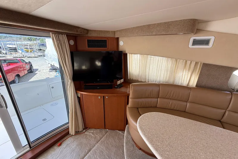 Slide: The Image of Interior of 2005 Silverton 38 Sport Bridge with TV, leather seating, and large window. - 10