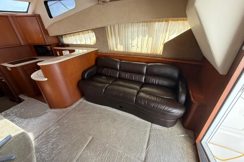 Slide: The Image of Interior of 2005 Silverton 38 Sport Bridge with leather sofa and kitchenette. - 12
