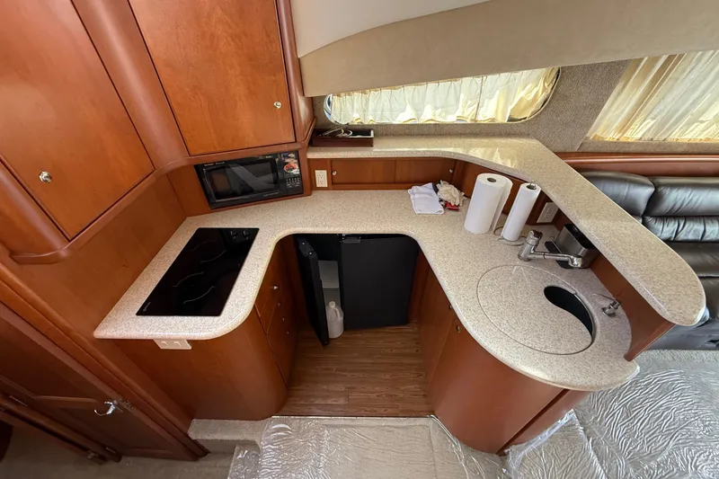 Slide: The Image of 2005 Silverton 38 Sport Bridge kitchen with modern appliances and sleek countertops. - 13