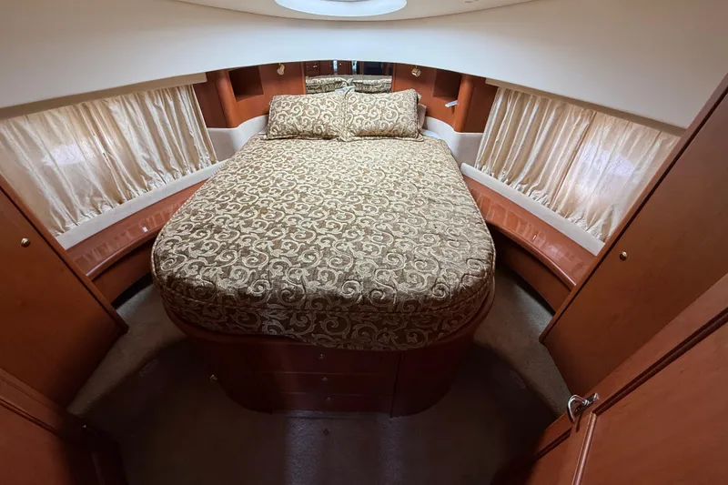 Slide: The Image of Luxurious bedroom interior of 2005 Silverton 38 Sport Bridge yacht with elegant bedding. - 16