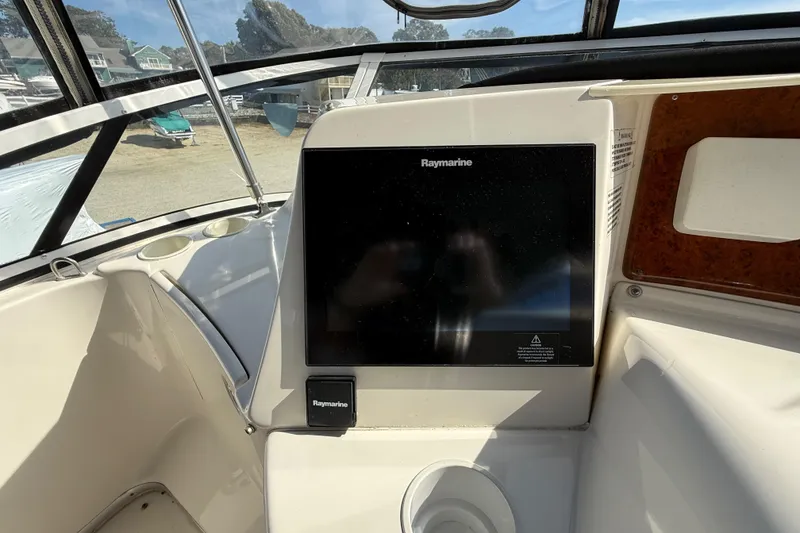 Slide: The Image of 2005 Silverton 38 Sport Bridge helm with Raymarine navigation display. - 21
