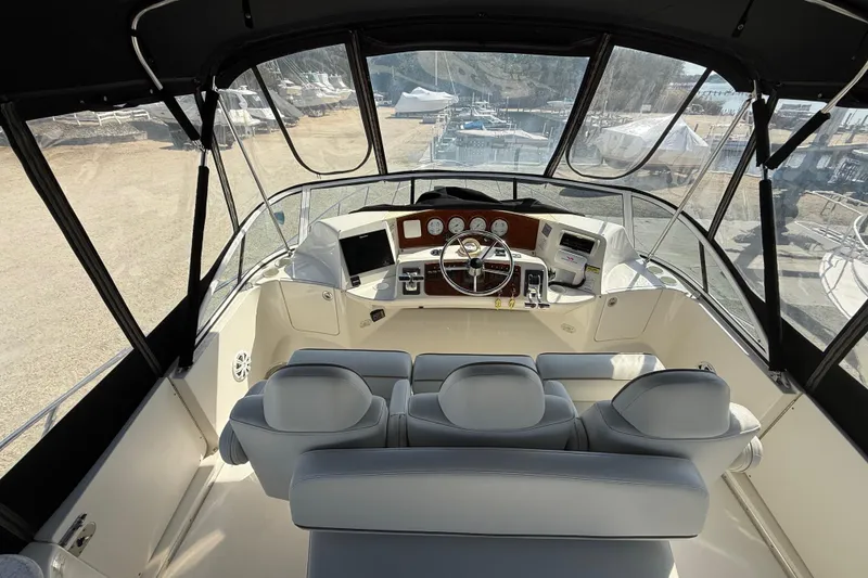 Slide: The Image of 2005 Silverton 38 Sport Bridge helm with modern controls and panoramic view. - 22