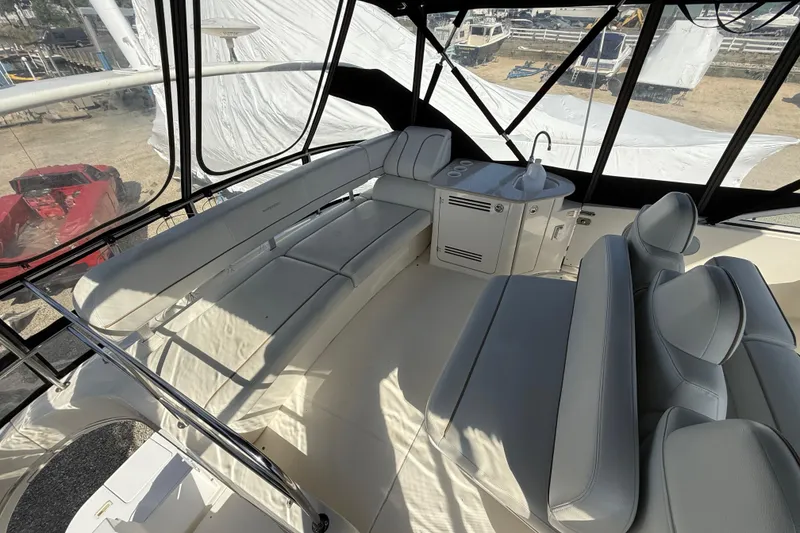 Slide: The Image of 2005 Silverton 38 Sport Bridge interior with seating and sink, showcasing luxury yacht design. - 23