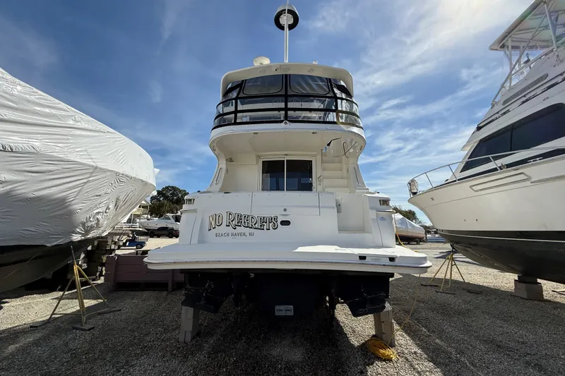 Slide: The Image of 2005 Silverton 38 Sport Bridge yacht on dry dock, labeled "No Regrets," Beach Haven, NJ. - 4
