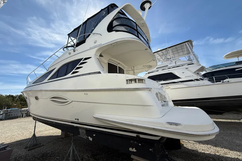 Slide: The Image of 2005 Silverton 38 Sport Bridge yacht on display, showcasing sleek design and spacious deck. - 5
