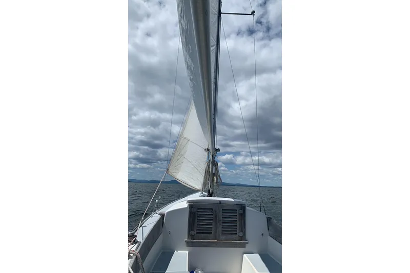 Slide: The Image of Sailing on a 1970 Bluenose One Design boat under cloudy skies. - 3