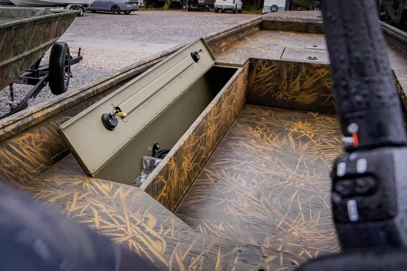 Slide: The Image of 2026 G3 17DK boat interior with open storage compartment, camo design. - 12