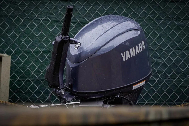 Slide: The Image of Yamaha outboard motor on G3 17DK boat, 2026 model, with raindrops, against chain-link fence. - 4