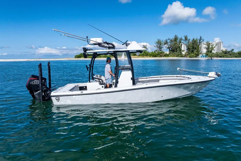 Slide: The Image of 2020 Barker Boatworks 26 Open on calm water, clear sky, coastal background. - 2
