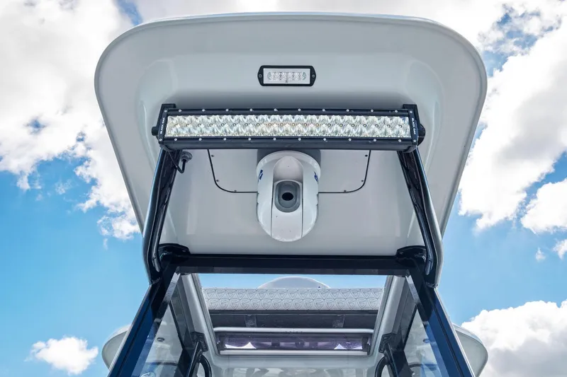 Slide: The Image of 2020 Barker Boatworks 26 Open T-top with LED lights against blue sky. - 20