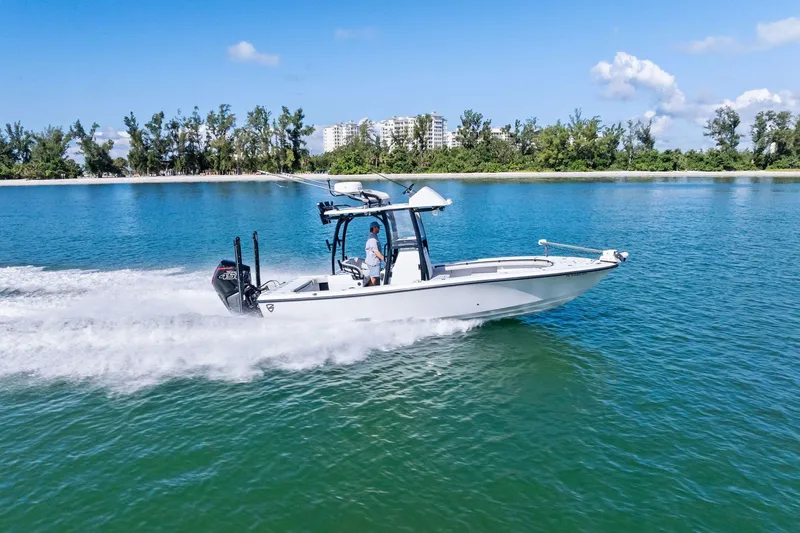 Slide: The Image of 2020 Barker Boatworks 26 Open cruising on clear blue water near a lush shoreline. - 33
