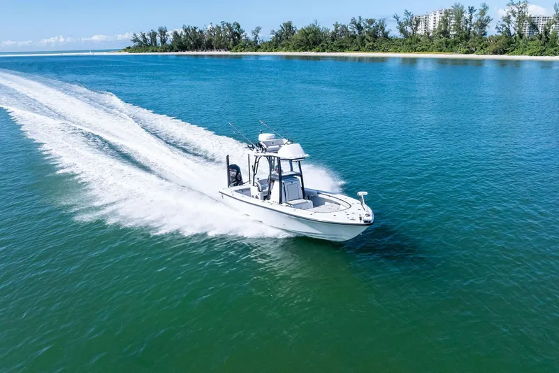 Slide: The Image of 2020 Barker Boatworks 26 Open cruising on clear blue water near a lush shoreline. - 34