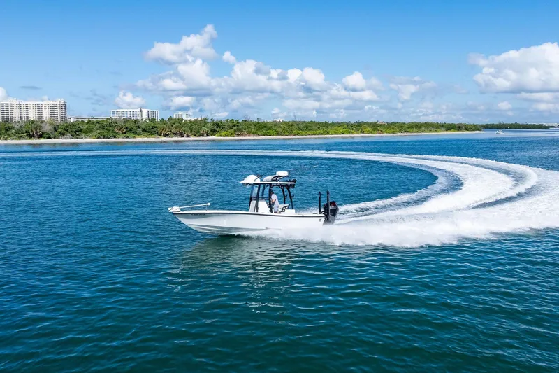 Slide: The Image of 2020 Barker Boatworks 26 Open cruising on blue water with scenic shoreline backdrop. - 37