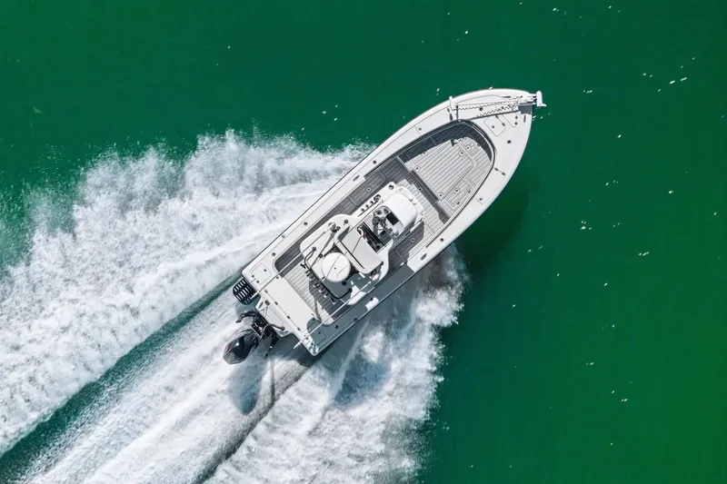 Slide: The Image of Aerial view of 2020 Barker Boatworks 26 Open speeding on green water. - 44