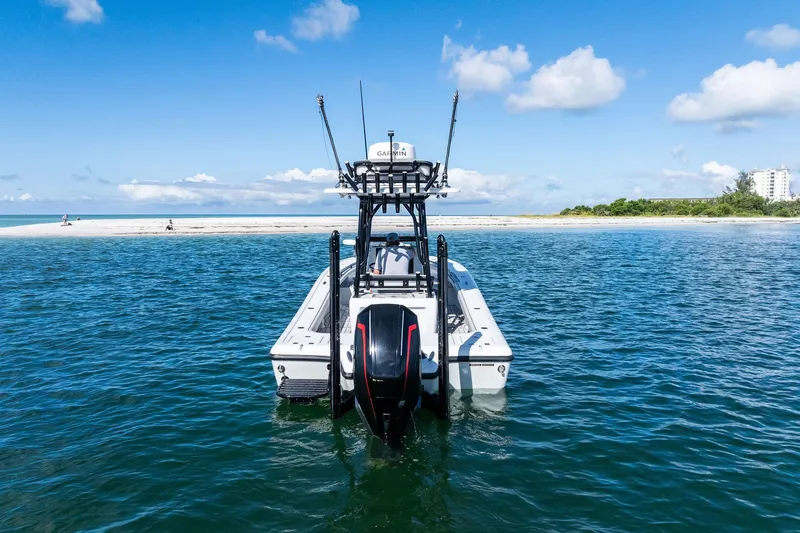 Slide: The Image of 2020 Barker Boatworks 26 Open on water near sandy beach, clear blue sky. - 6