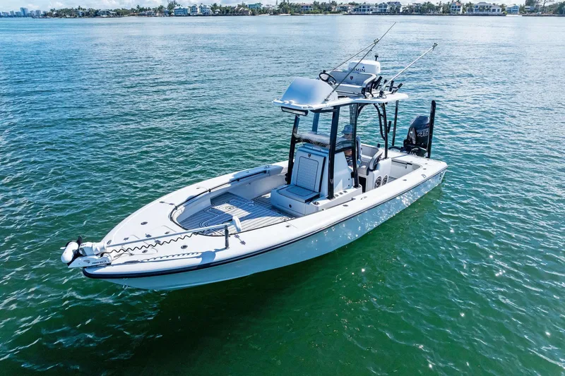 Slide: The Image of 2020 Barker Boatworks 26 Open on calm water, showcasing sleek design and fishing equipment. - 9