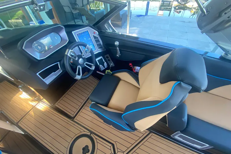 Slide: The Image of 2021 MasterCraft XT25 boat interior with modern dashboard and luxurious seating. - 22