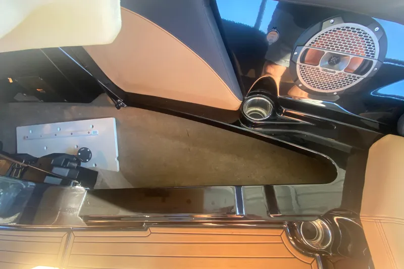 Slide: The Image of 2021 MasterCraft XT25 interior with speaker and cup holder detail. - 29