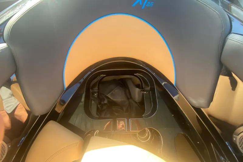 Slide: The Image of 2021 MasterCraft XT25 boat interior with tan and black seating. - 31