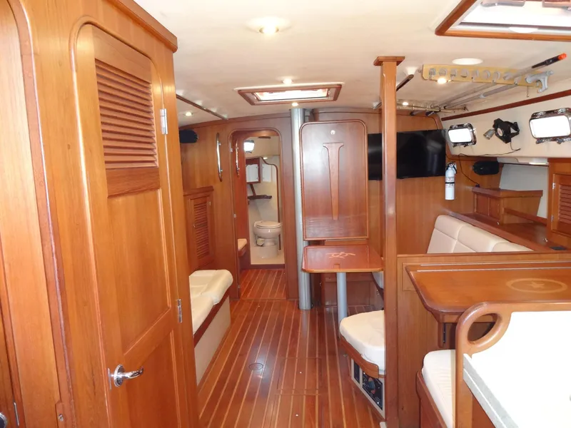 Slide: The Image of Interior of 2006 Island Packet 440 yacht with wooden finishes and seating area. - 2
