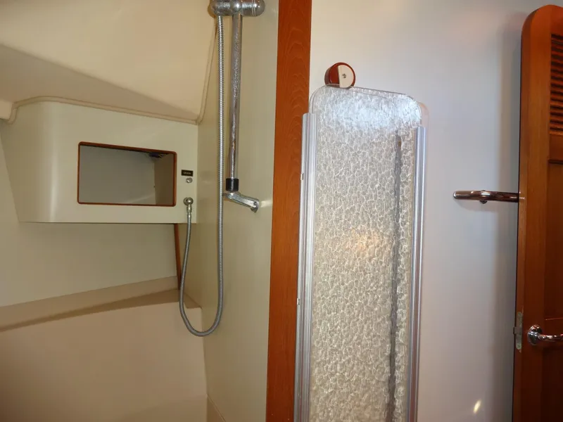 Slide: The Image of Bathroom interior of 2006 Island Packet 440 yacht, featuring shower and storage. - 38