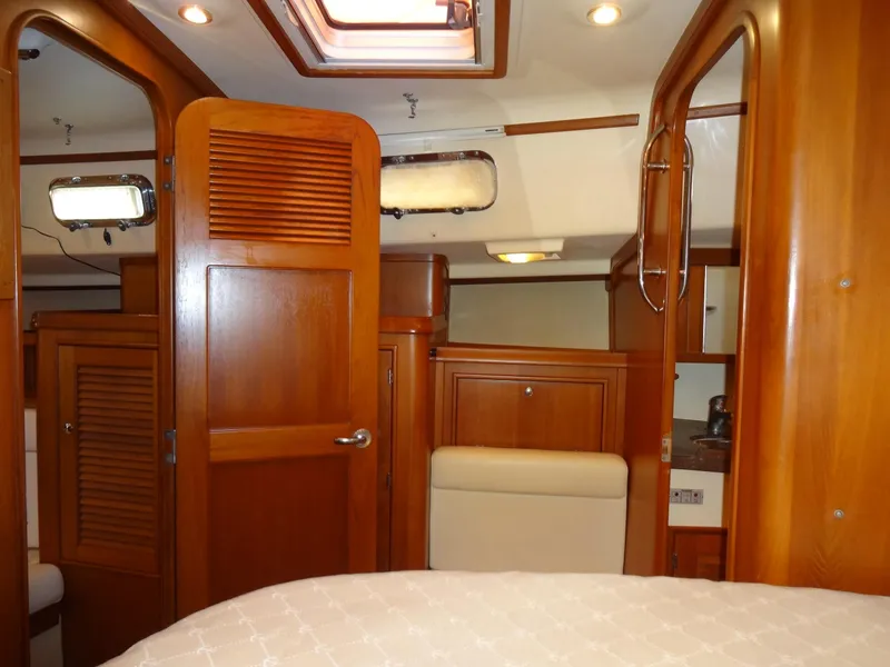 Slide: The Image of Interior of 2006 Island Packet 440 yacht, featuring wooden cabinetry and cozy design. - 44