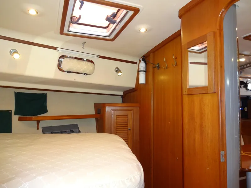 Slide: The Image of Interior of 2006 Island Packet 440 yacht with wooden cabinetry and cozy sleeping area. - 47