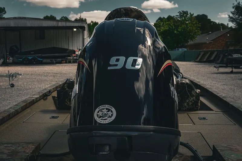 Slide: The Image of 2026 G3 Sportsman 1710 boat with 90 HP engine in a parking area. - 10