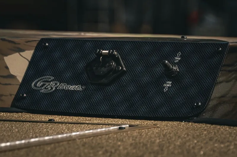 Slide: The Image of Control panel of 2026 G3 Sportsman 1710 boat with trim switch and logo. - 17