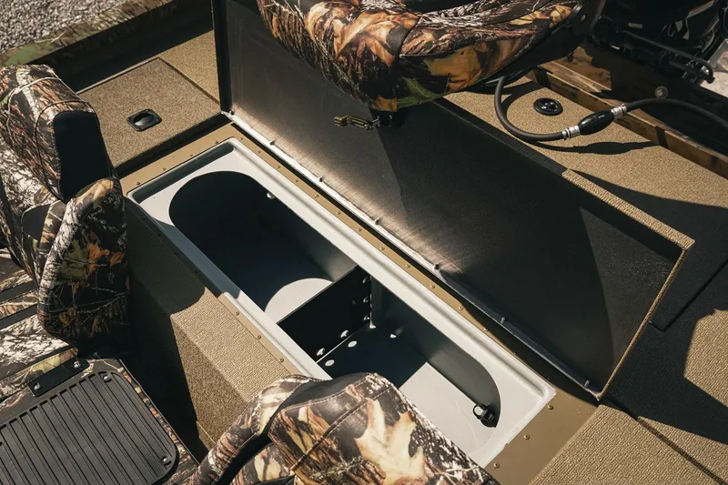 Slide: The Image of 2026 G3 Sportsman 1710 boat interior with camo seats and open storage compartment. - 30