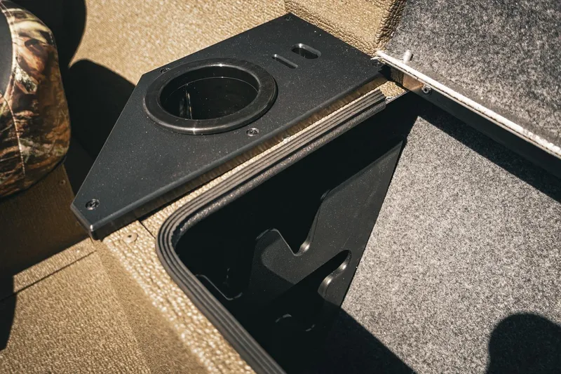Slide: The Image of 2026 G3 Sportsman 1710 boat interior with storage compartment and cup holder. - 34