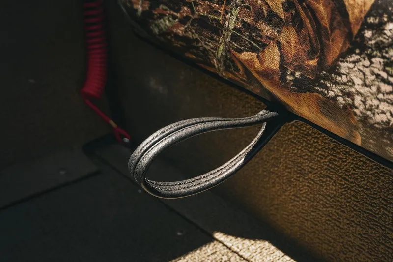 Slide: The Image of Close-up of G3 Sportsman 1710 boat interior detail, featuring a camo-patterned seat and handle. - 35