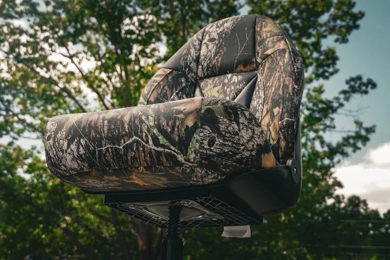 Slide: The Image of Camo-patterned seat of 2026 G3 Sportsman 1710 boat against a leafy background. - 6