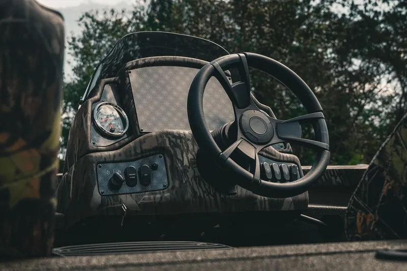 Slide: The Image of 2026 G3 Sportsman 1710 boat dashboard with steering wheel and controls. - 8