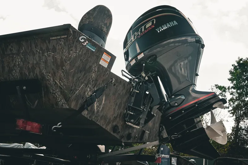 Slide: The Image of 2026 G3 Sportsman 1710 boat with Yamaha outboard motor, camo design, rear view. - 9