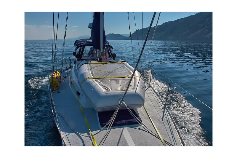 Slide: The Image of 1981 Jensen Marine/Cal Boats 39 MK III sailing on calm waters, scenic coastal view. - 14