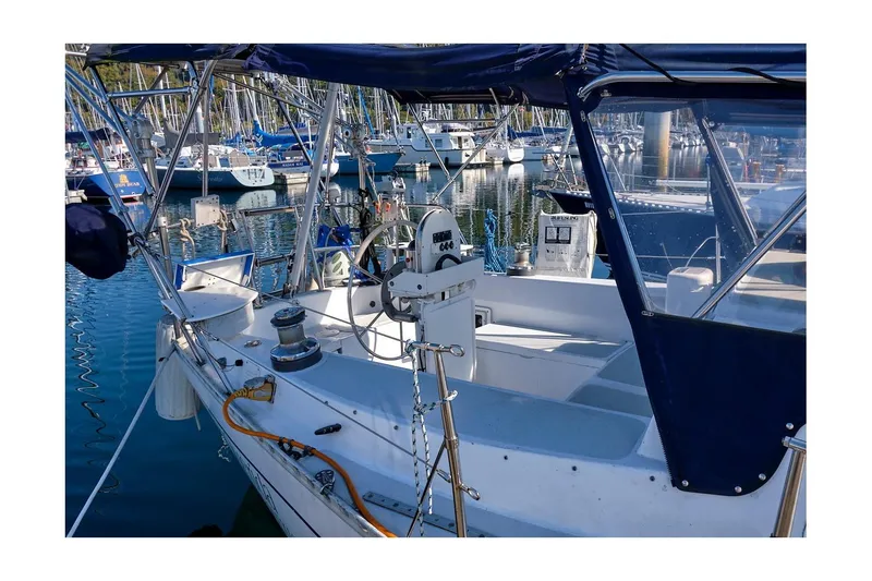 Slide: The Image of 1981 CAL 39 MK III sailboat docked in marina, featuring cockpit and steering wheel. - 17