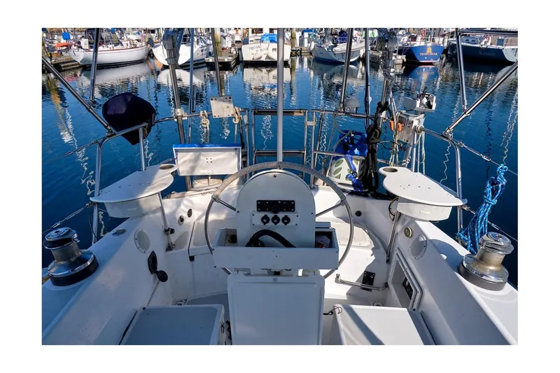 Slide: The Image of Cockpit of 1981 CAL 39 MK III sailboat docked in marina, surrounded by other boats. - 18