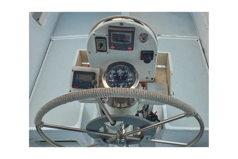 Slide: The Image of Cockpit of 1981 Jensen Marine/Cal Boats 39 MK III with steering wheel and navigation instruments. - 21
