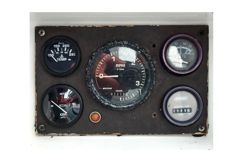 Slide: The Image of Instrument panel of a 1981 Jensen Marine/Cal Boats 39 MK III, featuring various gauges. - 22