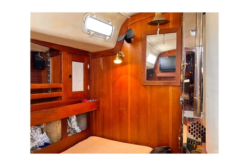 Slide: The Image of Interior of 1981 Jensen Marine Cal 39 MK III sailboat with wood paneling and cozy cabin. - 30